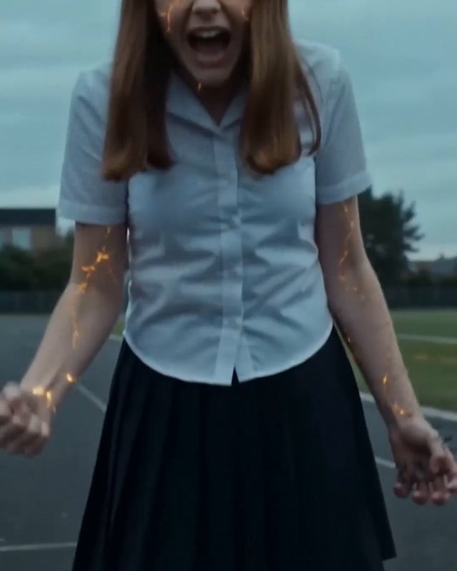 Girl with glowing eyes in a school uniform